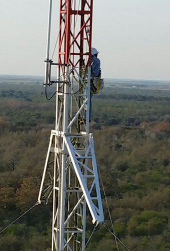 Elite Technician Jacob climbs a tower in Normangee, TX