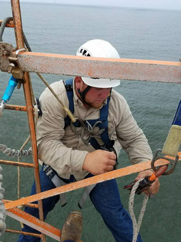 Elite Technician Travis installs pulley on a tower offshore